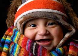 A baby wearing many items of winter clothing: headband, cap, fur-lined coat, wool neckscarf and sweater. (Courtesy of Wikimedia Commons. Author: Andrew Vargas from Clovis, United States)